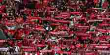 Benfica supporters raise their scarves aloft. 