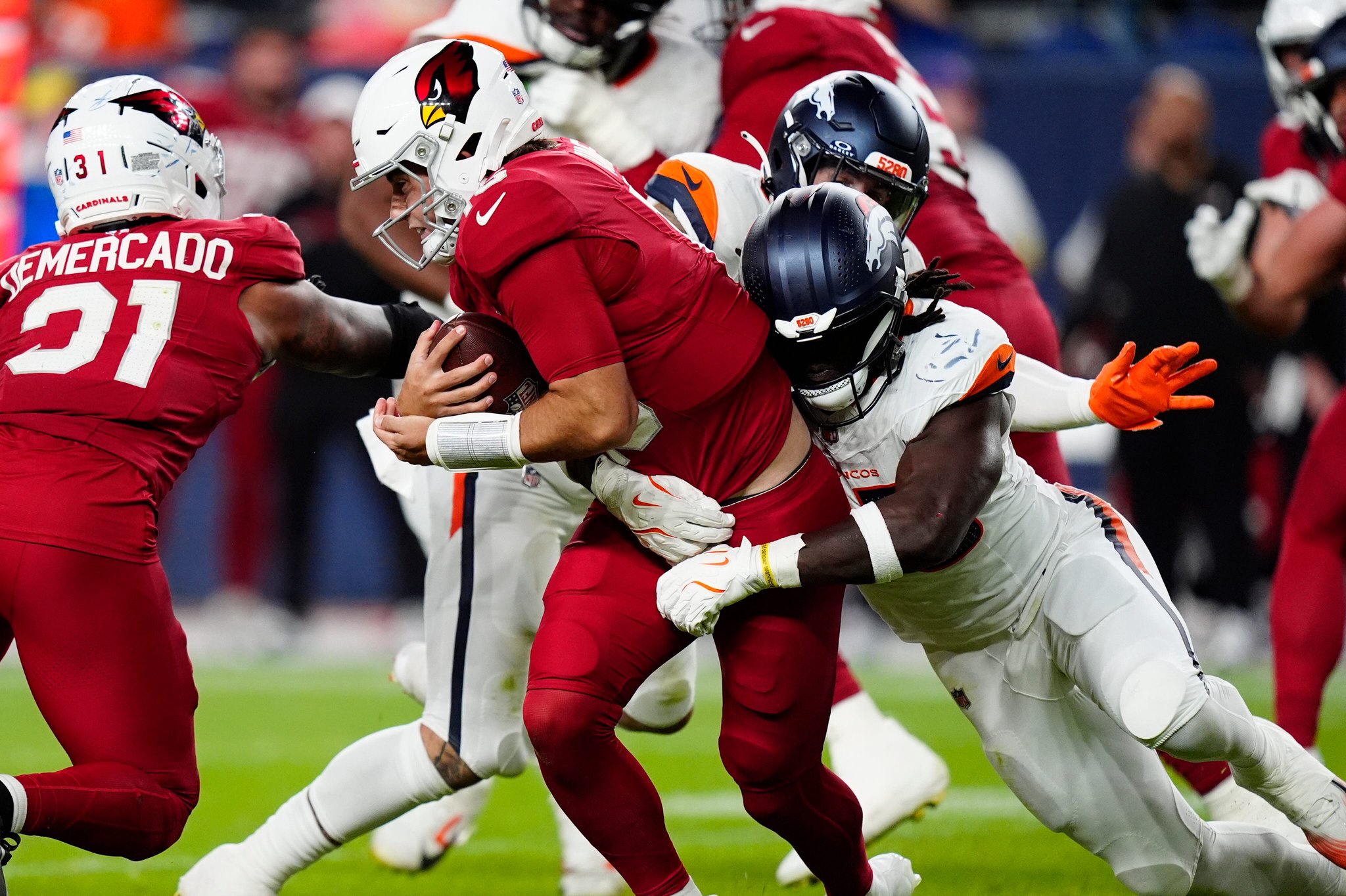 Denver Broncos linebacker Jordan Turner (55) sacks Arizona Cardinals quarterback Clayton Tune (15) in the second half at Empower Field at Mile High. Mandatory Credit: Ron Chenoy-Imagn Images