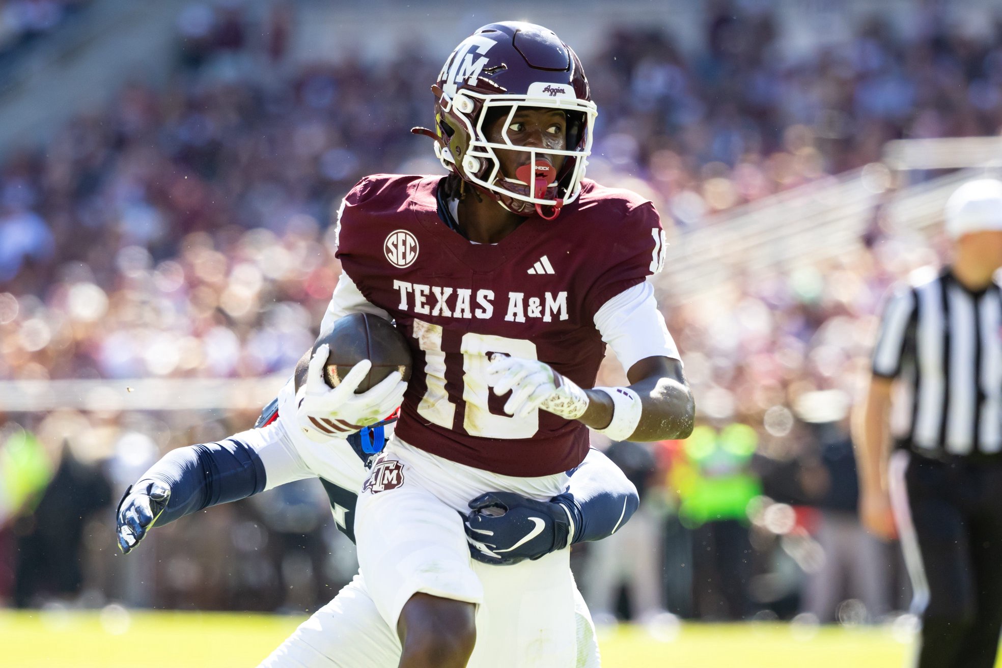 Nov 22, 2025; College Station, Texas, USA; Texas A&M Aggies wide receiver TK Norman (18) runs with the ball in the first half of a game against the Samford Bulldogs at Kyle Field. Mandatory Credit: Joseph Buvid-Imagn Images