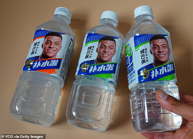 Bottled Dongpeng electrolyte drink endorsed by French football star Kylian Mbappe are displayed for sale at a shop on October 27