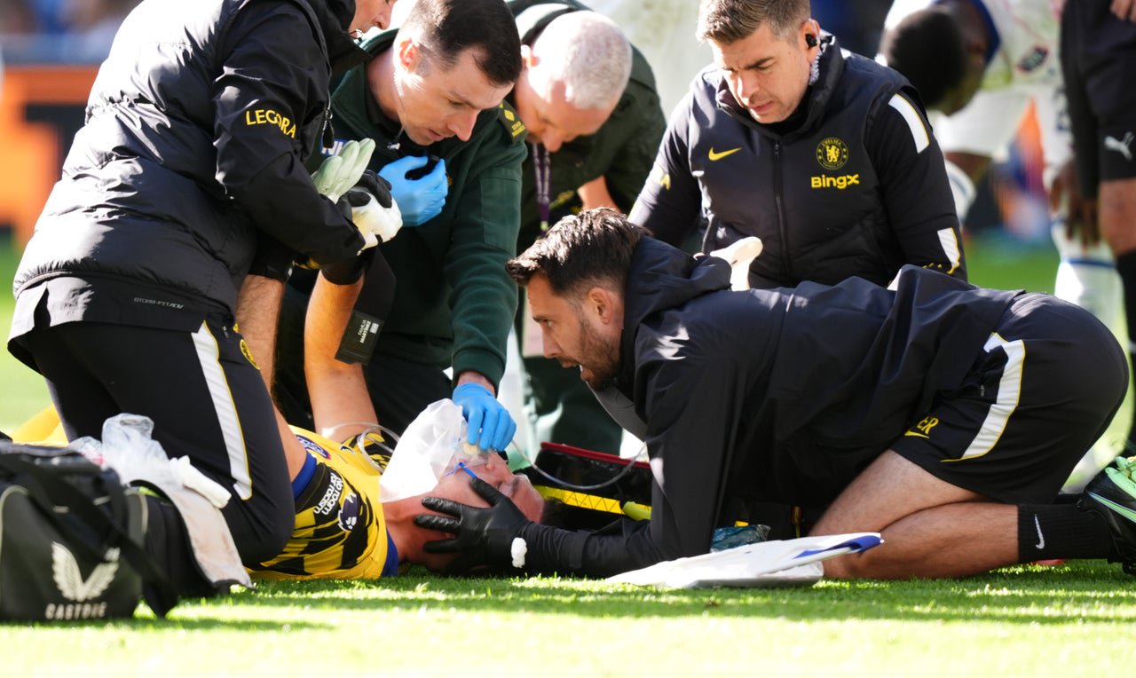 Chelsea goalkeeper Emiliano Martinez receives oxygen as physios work with caution (PA)