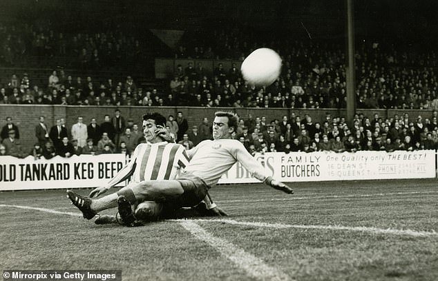 Frank Beattie is tackled by Manfred Geisler of Locomotive Leipzig during a Fairs Cup match in 1967
