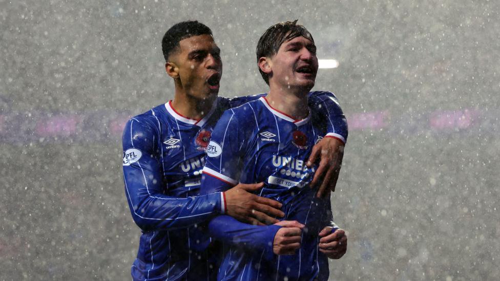 Kevin Kelsy and Ryan Naderi celebrate