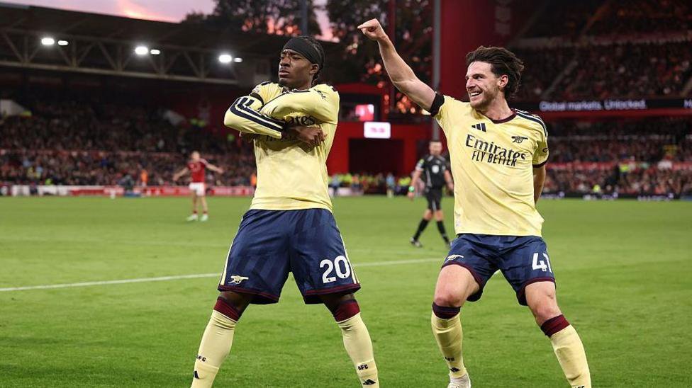 Noni Madueke celebrates with Declan Rice.