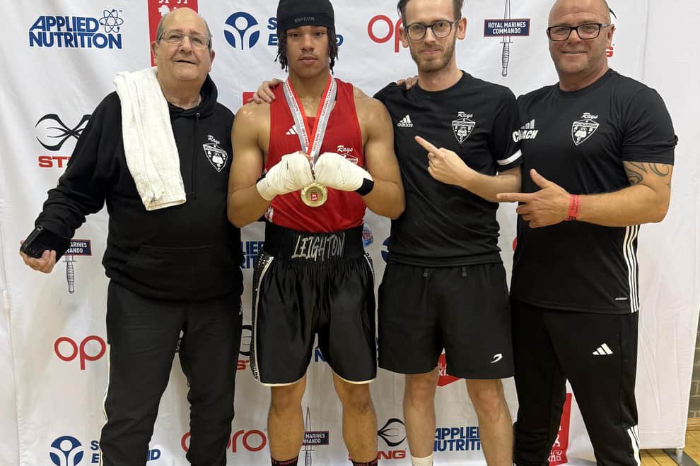 Leighton Forbes celebrates his success with the Wellingborough ABC backroom team