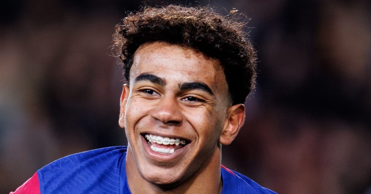Spain footballer Lamine Yamal smiling while playing for La Liga team Barcelona Football Club in a blue and red striped top