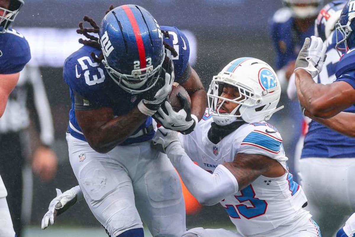 Sep 27, 2026; East Rutherford, New Jersey, USA; New York Giants running back Najee Harris (23) is tackled by Tennessee Titans safety Kevin Winston Jr. (23) during the first half at MetLife Stadium. © Vincent Carchietta-Imagn Images