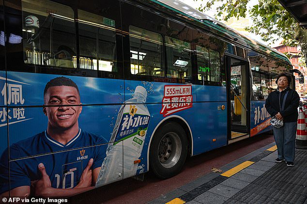 A bus featuring French football star Kylian Mbappe for Dongpeng's Bushuila electrolyte drink is seen on a street in Shanghai on October 27