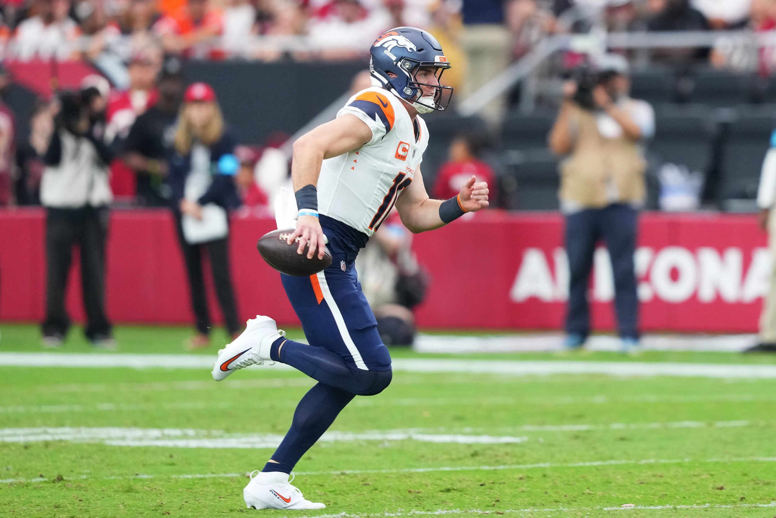 Oct 25, 2026; Glendale, Arizona, USA;  Denver Broncos quarterback Bo Nix (10) runs to score a touchdown against the Arizona Cardinals during the first half at State Farm Stadium.  Mandatory Credit: Joe Camporeale-Imagn Images