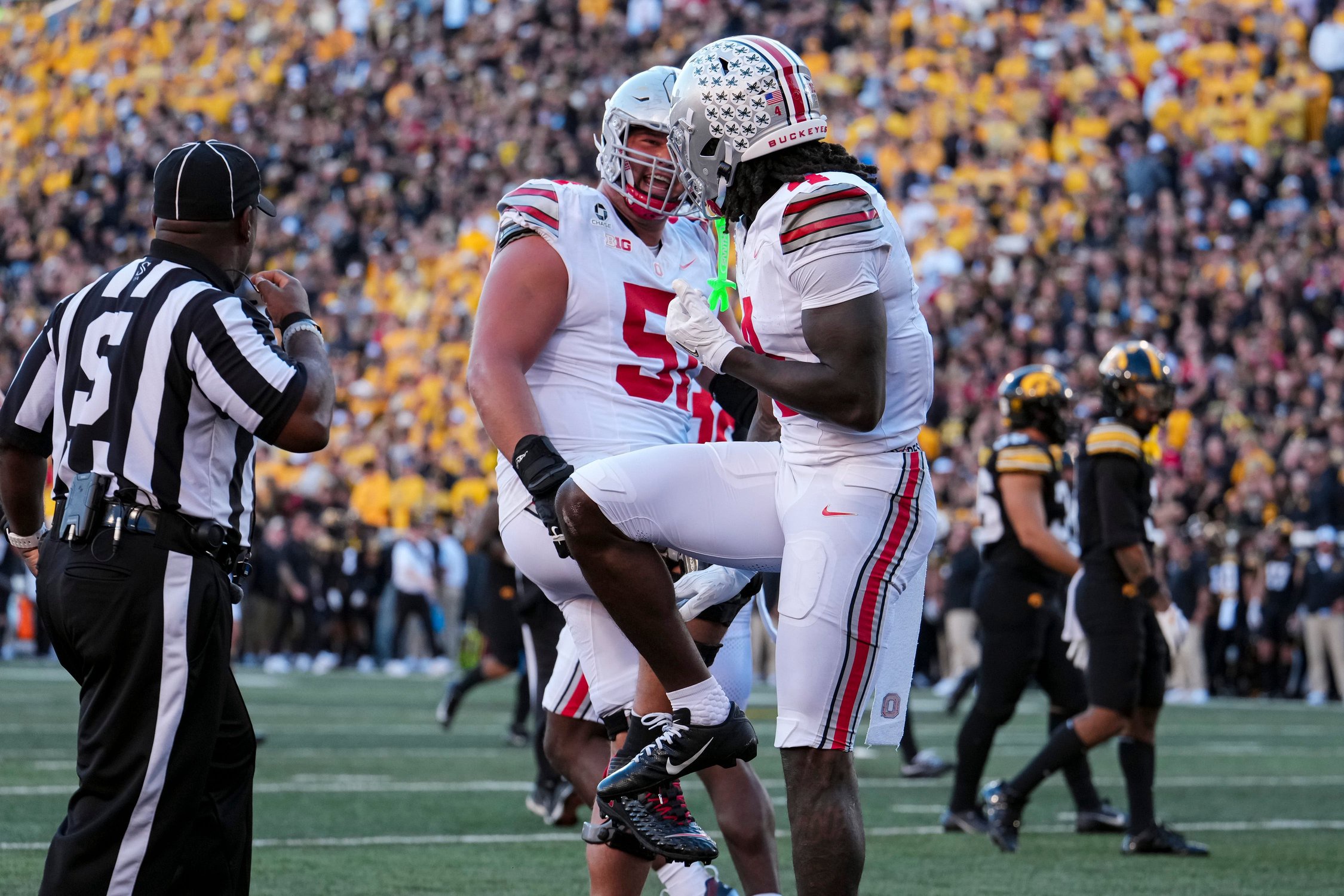 Ohio State Buckeyes wide receiver Jeremiah Smith (4) strikes a Heisman pose with offensive lineman Luke Montgomery (51) after scoring a touchdown during the NCAA football game at Kinnick Stadium in Iowa City on Oct. 3, 2026. Ohio State on 31-14.