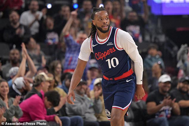 Los Angeles Clippers' Darius Garland heads down court after a 3-point basket during an NBA basketball game against the Sacramento Kings, Wednesday, Oct. 21, 2026, in Los Angeles. (AP Photo/Jayne Kamin-Oncea)