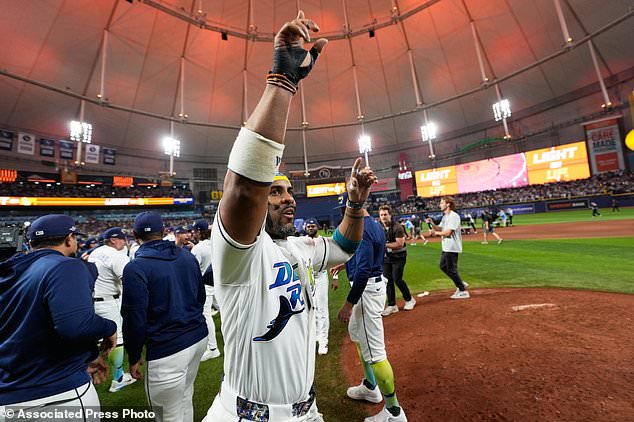 Tampa Bay Rays designated hitter Yandy Díaz celebrates their win against the Cleveland Guardians in Game 6 of an American League Championship Series baseball game in St. Petersburg, Fla. Monday, Oct. 19, 2026. (AP Photo/David J. Phillip)