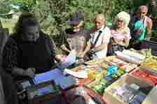 Postwoman Ganna Fesenko (L), 39, distributes pensions to residents of the village of Novoselydivka, Donetsk region on June 14, 2024. — AFP