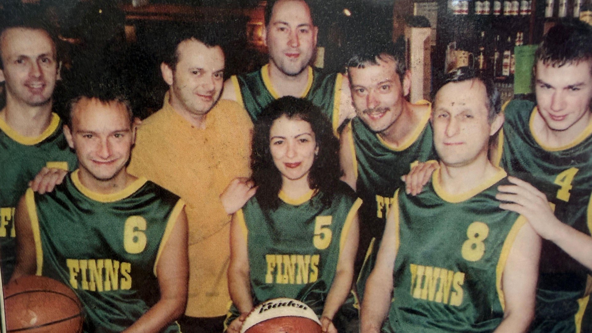 A vintage colour photo of basket ball players in green Finns tops