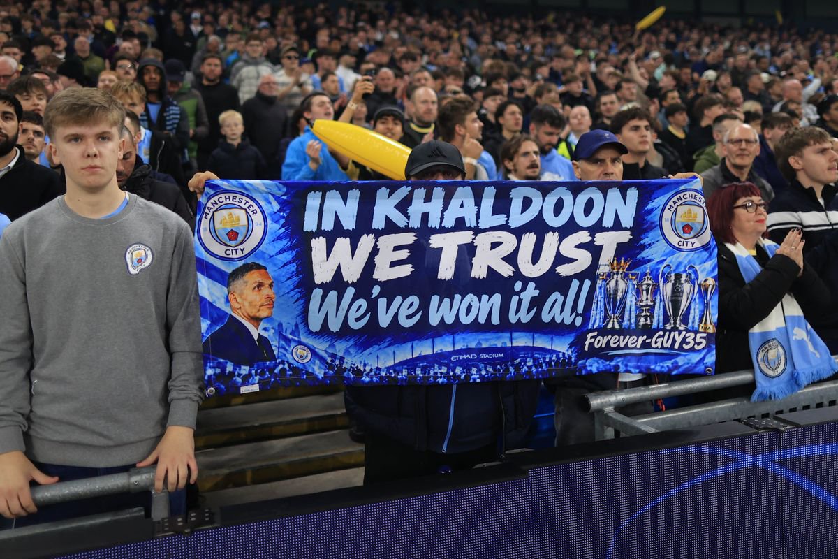  A Manchester City fan holds up a banner in support of the club chairman Khaldoon Al Mubarak during the UEFA Champions League 2026/27 League Phase MD2 match between Manchester City and Paris Saint-Germain at City of Manchester Stadium on October 14, 2026 in Manchester, United Kingdom