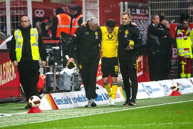 Borussia's Konstantinos Karetsas is carried off the field due to injury, during the Bundesliga soccer match between Union Berlin and Borussia Dortmund, in Berlin, Saturday, Oct. 17, 2026. (Julius Frick/dpa via AP)