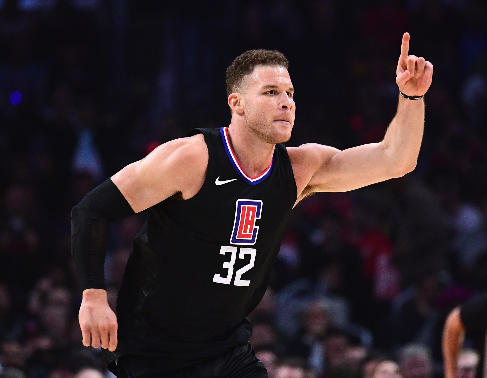Los Angeles Clippers player Blake Griffin points upward while on the court.