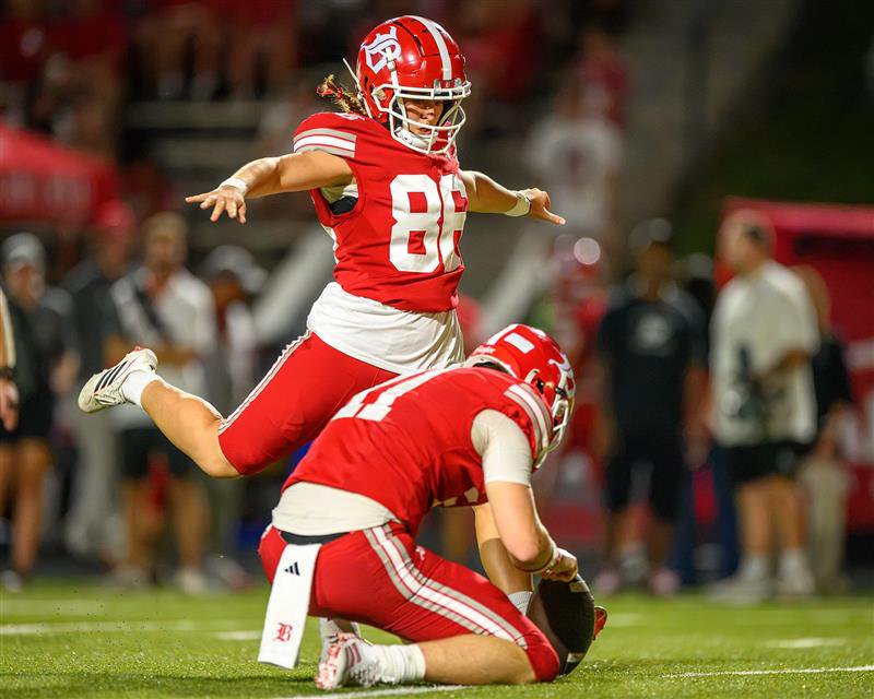 Baylor School senior kicker Ella Metzner (86) attempts an extra point for the Red Raiders.