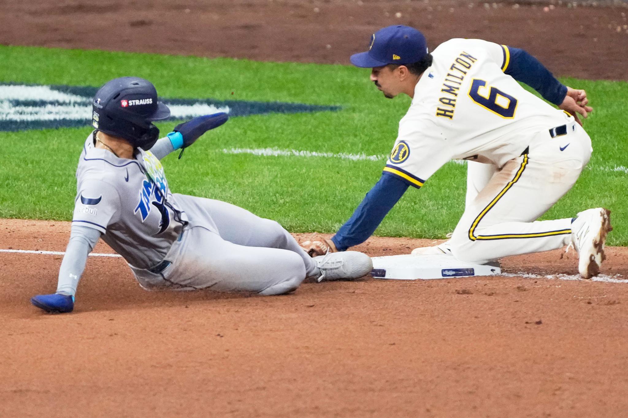 Tampa Bay Rays' Victor Mesa Jr. is tagged out stealing by Milwaukee Brewers third baseman David Hamilton.
