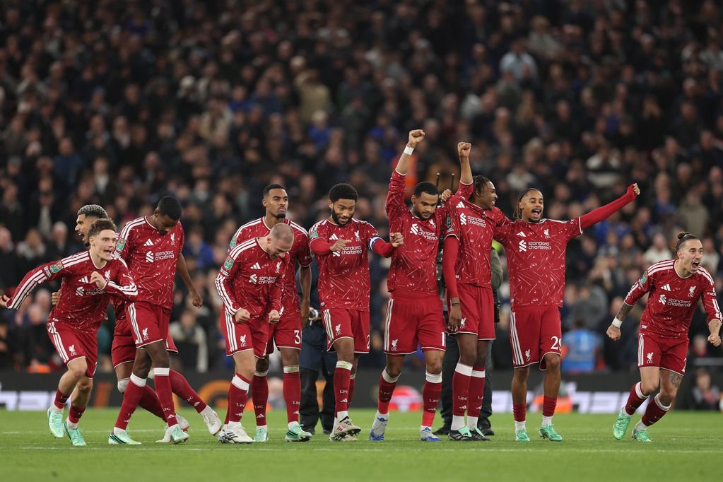 Liverpool players celebrate winning the penalty shootout