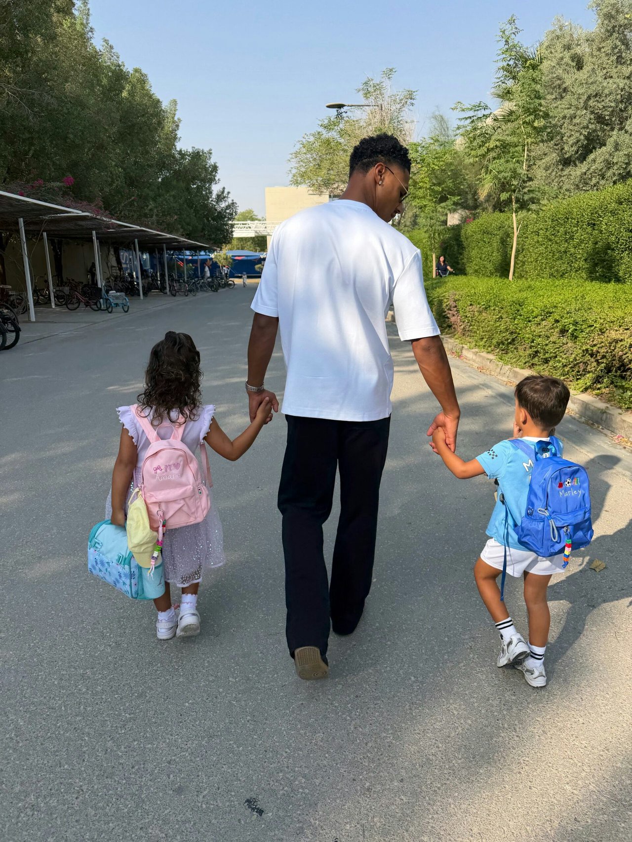 Ollie Watkins holding hands with his children Amara and Marley.