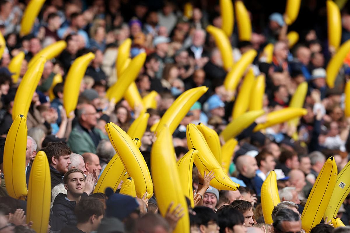 Manchester City supporters wave inflatable bananas in the Premier League.