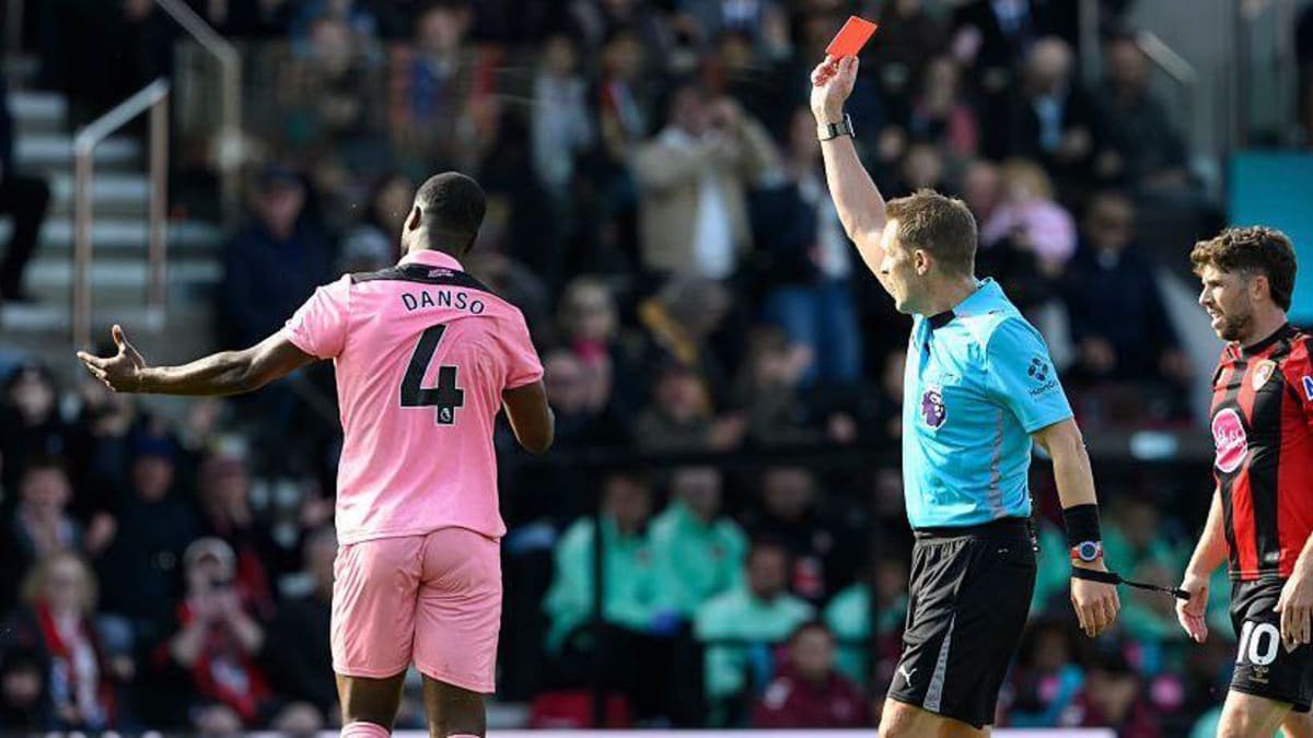 Sunderland's Kevin Danso (left) is shown a red card by referee Craig Pawson