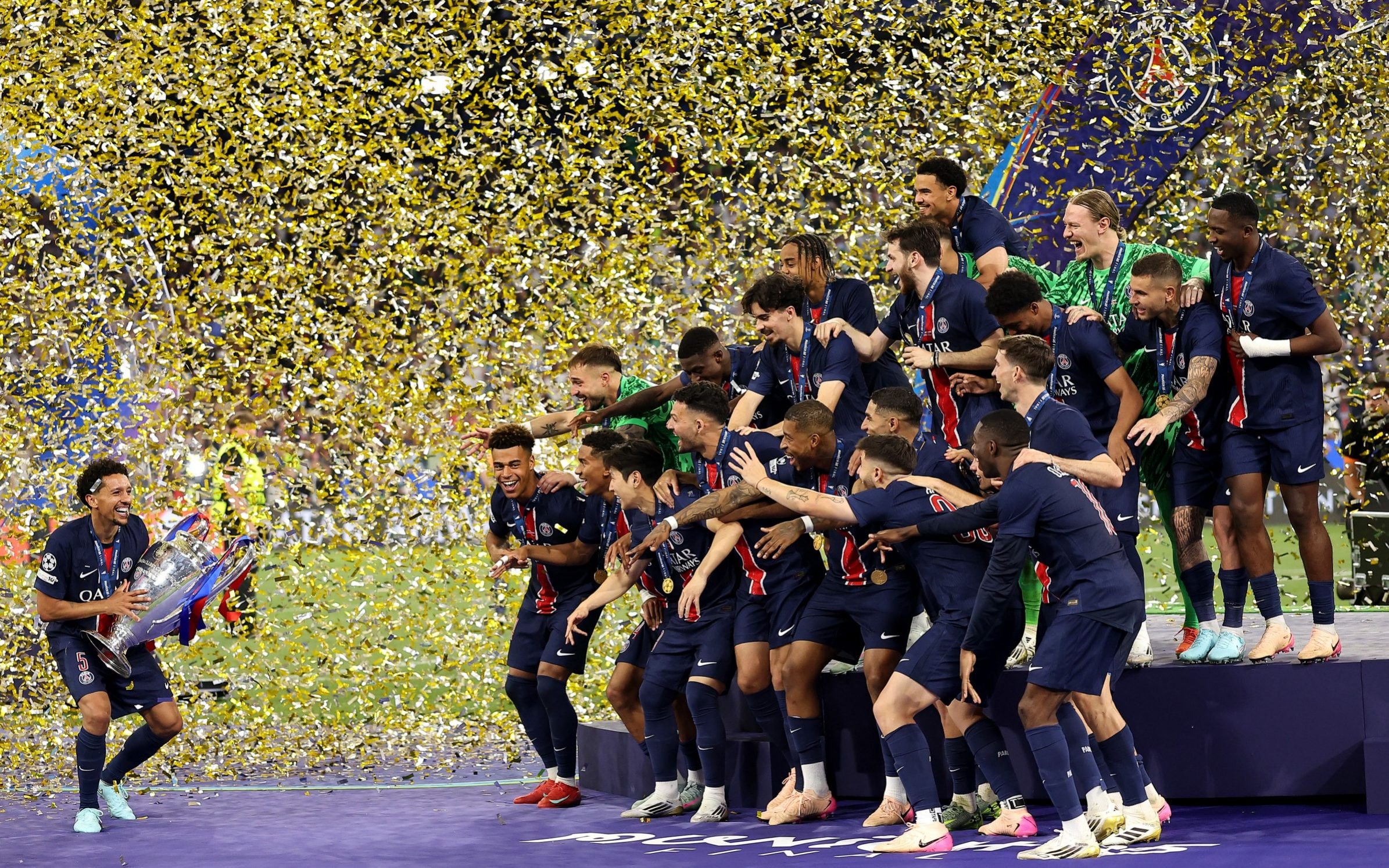 Marquinhos of Paris Saint-Germain prepares to lift the 2025 UEFA Champions League trophy