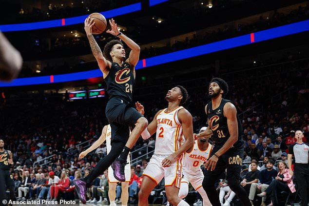 Cleveland Cavaliers guard Tyrese Proctor (24) drives against Atlanta Hawks guard Aaron Wiggins (2) during the first half of an NBA basketball game, Thursday, Oct. 29, 2026, in Atlanta. (AP Photo/Erik S. Lesser)
