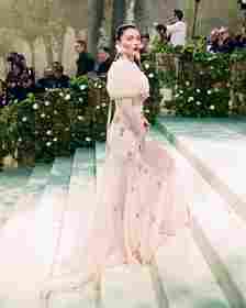 Image may contain Eve Hewson Clothing Dress Formal Wear Fashion Gown Person Wedding Wedding Gown and Plant