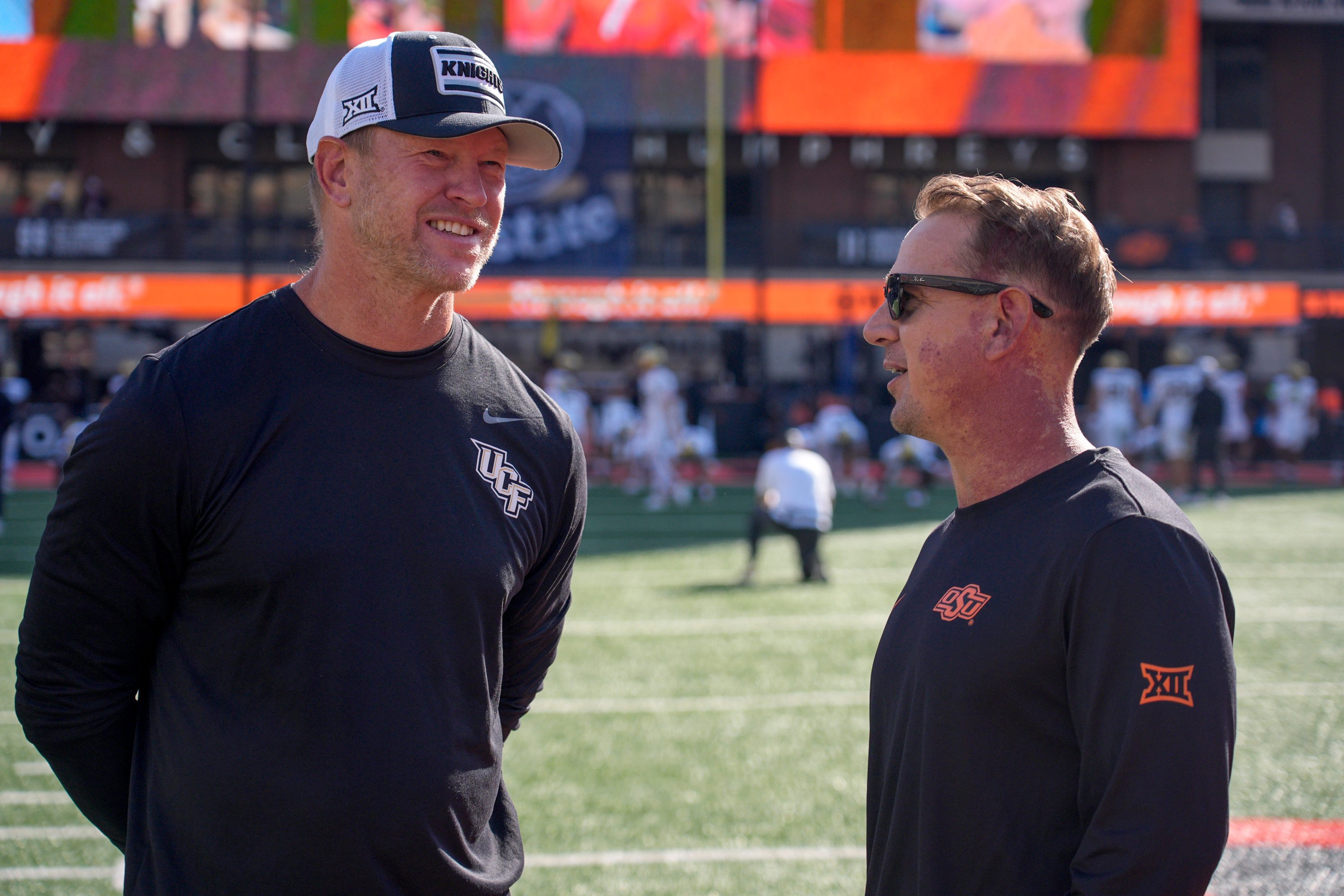 UCF head coach Scott Frost and OSU head coach Eric Morris meet on the field before an NCAA football game between the Oklahoma State University (OSU) Cowboys and the University of Central Florida (UCF) Knights at Boone Pickens Stadium in Stillwater, Okla., on Saturday, Oct. 10, 2026.