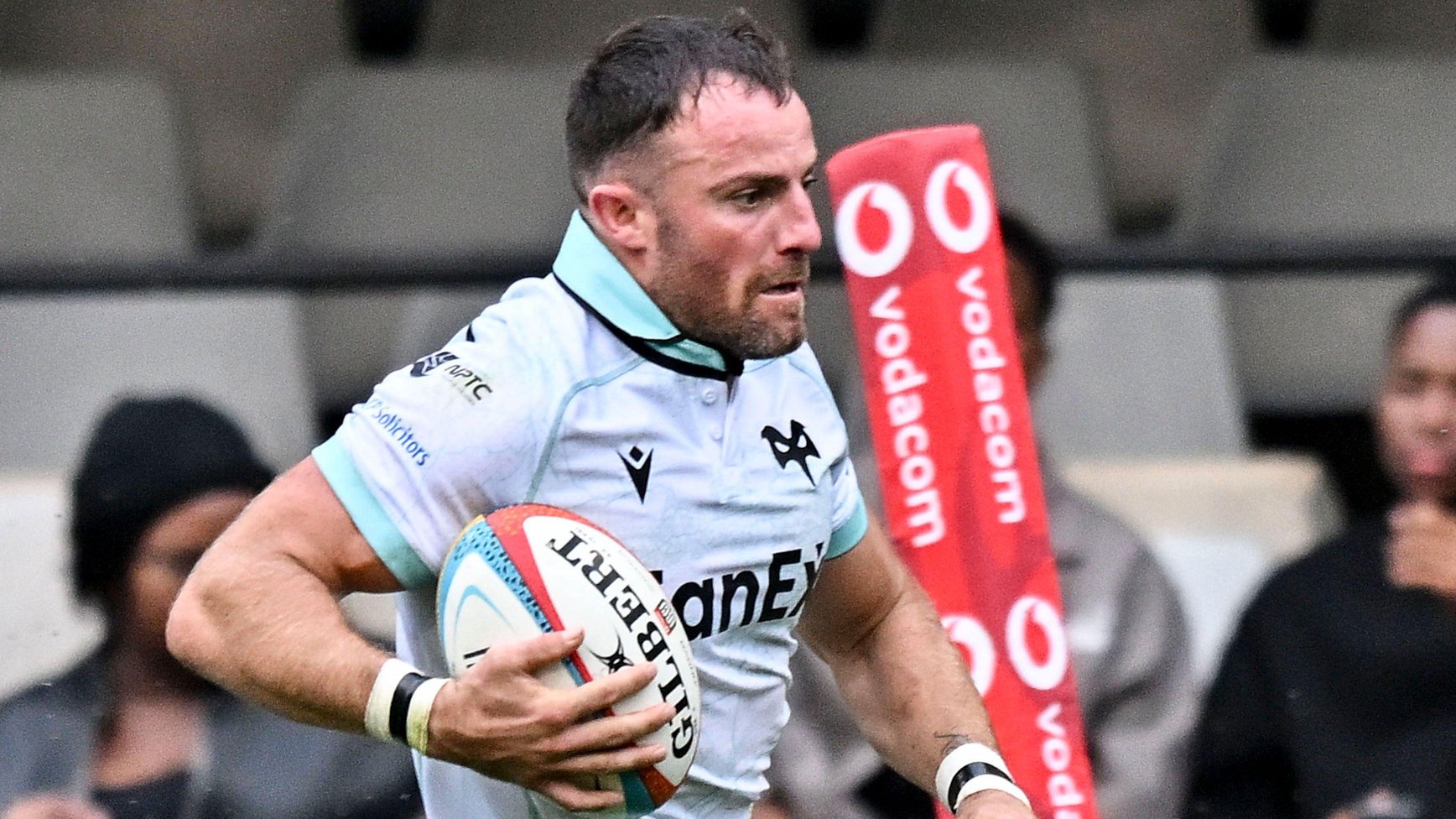 Luke Morgan runs with the ball under his right arm for Ospreys