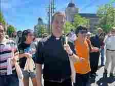 The Rev. Brendan Glasgow, center, and youth Juan Diego Pantoj, right, participate in the National Eucharistic Pilgrimage, Saturday morning, June 8, 2024, in Washington, D.C. (RNS photo/Aleja Hertzler-McCain)