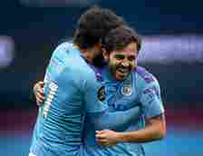 David Silva of Manchester City celebrates with Bernardo Silva during the Premier League match between Manchester City and AFC Bournemouth  at Etiha...