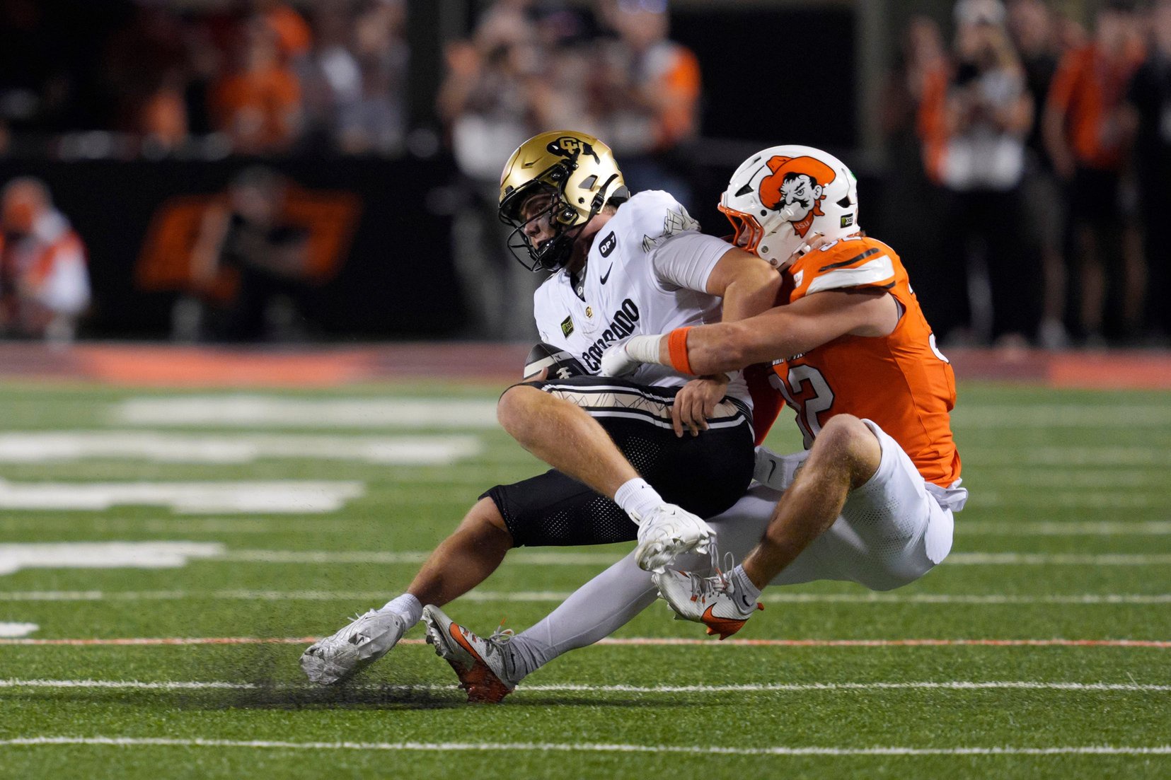 Oklahoma State Cowboys linebacker Ethan Wesloski (32) sacks Colorado Buffaloes quarterback Isaac Wilson (16) during a college football game between the Oklahoma State Cowboys (OSU) and the Colorado Buffaloes at Boone Pickens Stadium in Stillwater, Okla., Saturday, Oct. 24, 2026. Oklahoma State won 57-24.