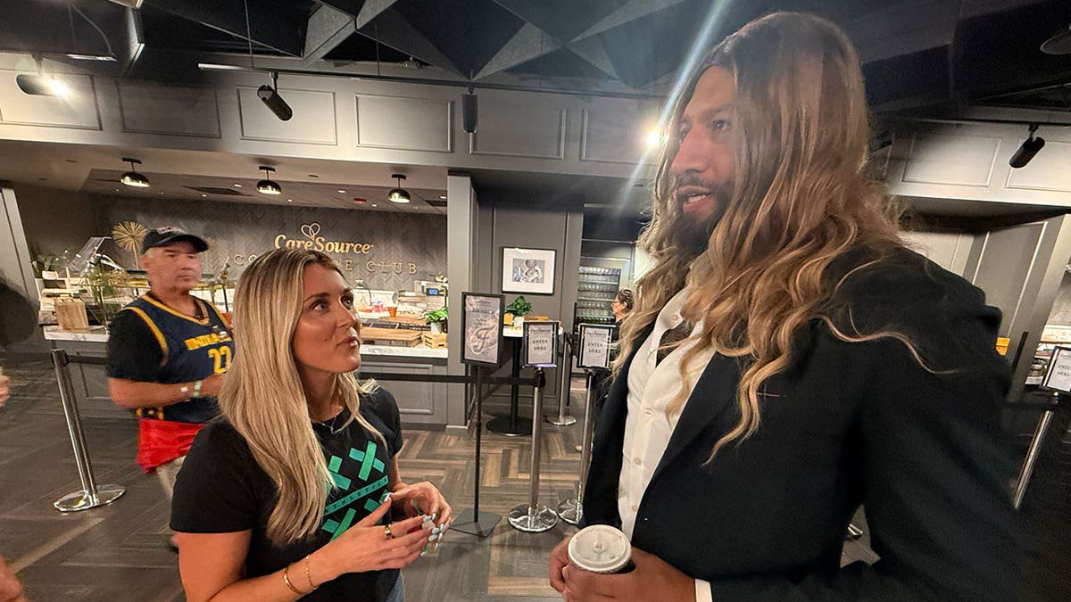 Former NBA player Royce White, who declared for the 2027 WNBA Draft as a way to push the WNBA to define a woman, talks with Riley Gaines at an Indiana Fever game.