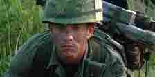 Forrest (Tom Hanks) in his soldier uniform, loaded down with gear in Vietnam in Forrest Gump.