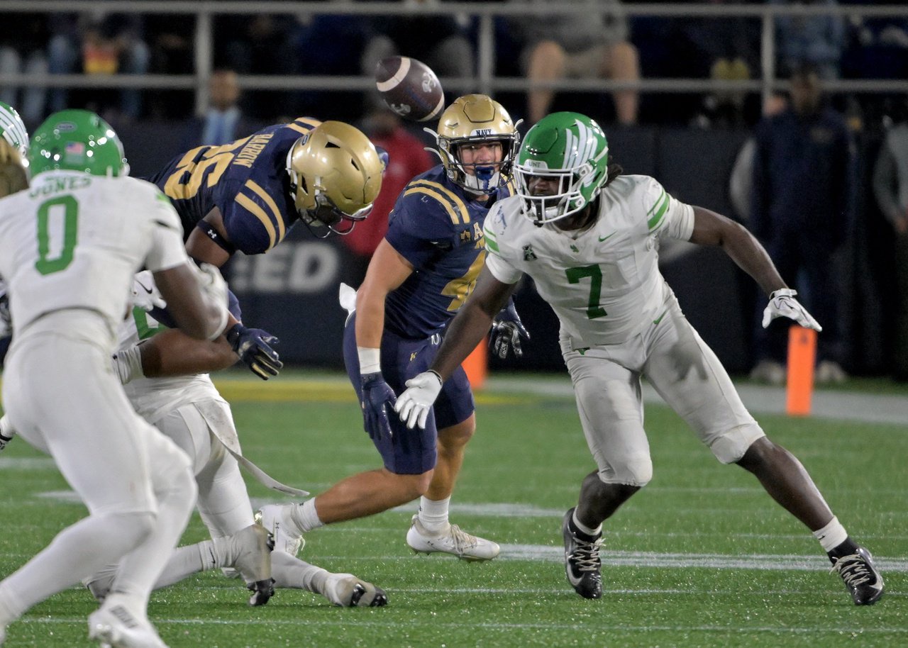 Navy Midshipmen running back Michael Barrow #26 fumbles the ball out of bounds in the fourth quarter. The visiting North Texas Mean Green defeat the Navy Midshipmen, 49-39, in an NCAA football game Saturday at Navy-Marine Corps Memorial Stadium in Annapolis. (Paul W. Gillespie/Staff)