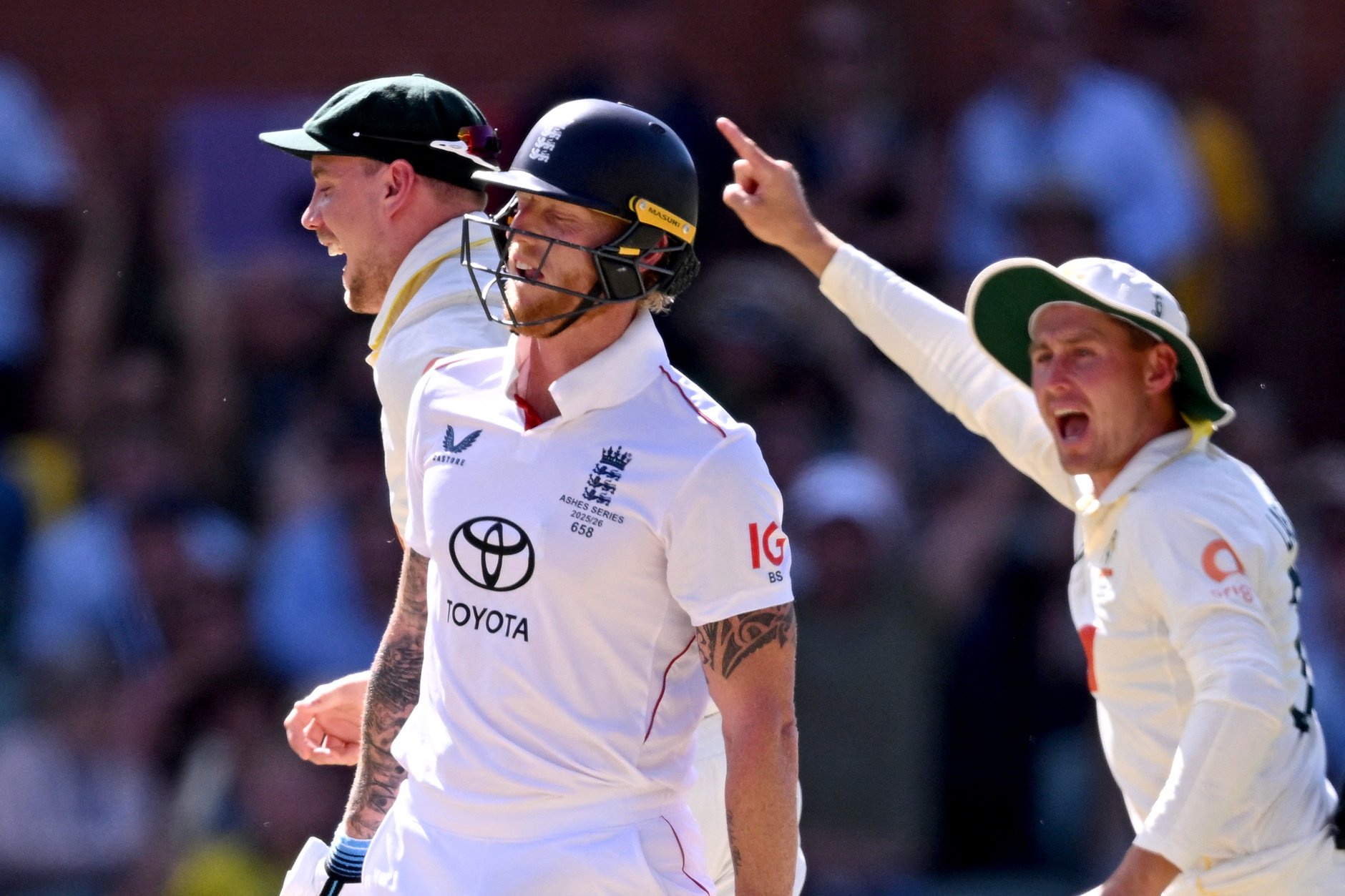  Ben Stokes (C) reacts after being bowled as Australian players Cameron Green (L) and Marnus Labuschagne (R) celebrate on the fourth day of the third Ashes cricket Test match between Australia and England at the Adelaide Oval in Adelaide