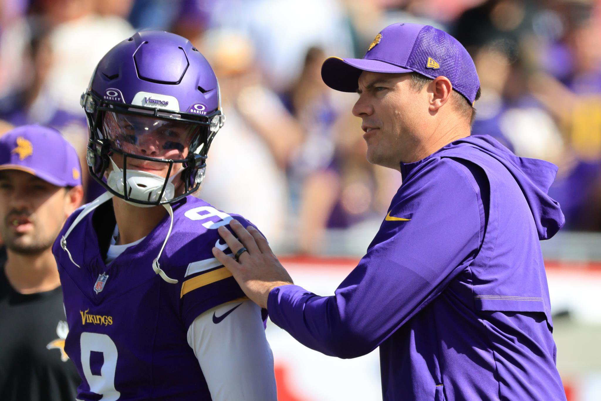 Minnesota Vikings head coach Kevin O'Connell greets quarterback J.J. McCarthy during warmups before a game against the Tampa Bay Buccaneers.