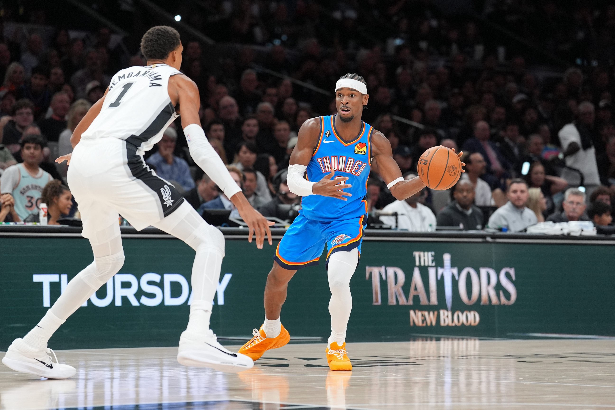 Oct 20, 2026; San Antonio, Texas, USA;  Oklahoma City Thunder guard Shai Gilgeous-Alexander (2) looks to pass the ball in against San Antonio Spurs forward Victor Wembanyama (1) in the first half at Frost Bank Center.  Mandatory Credit: Daniel Dunn-Imagn Images