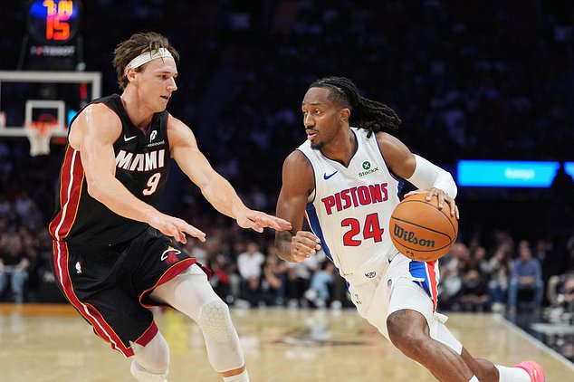 Detroit Pistons guard Daniss Jenkins (24) pushes forward defended by Miami Heat guard Pelle Larsson (9) during the first half of an NBA basketball game, Friday, Oct. 23, 2026, in Miami. (AP Photo/Rebecca Blackwell)