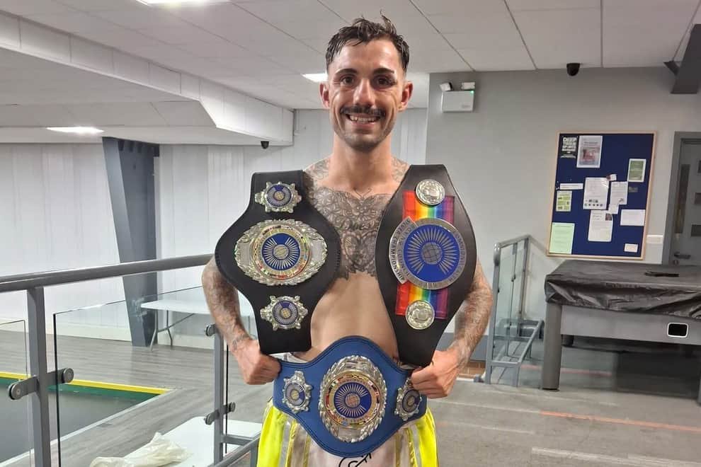 Liam Dring with his three championship belts,