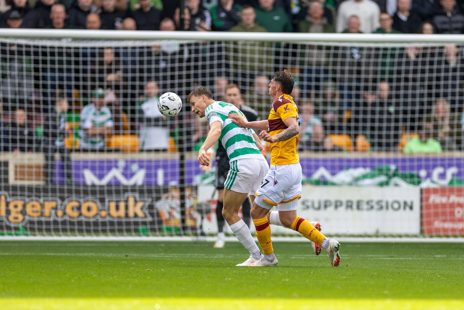 Dane Murray of Celtic wins the ball from Seb Palmer-Houlden of Motherwell in front of the goal at Fir Park
