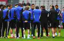 John Terry of Chelsea looks on as  Chelsea Interim Manager Rafael Benitez talks to the team during a Chelsea training session ahead of the UEFA Eur...