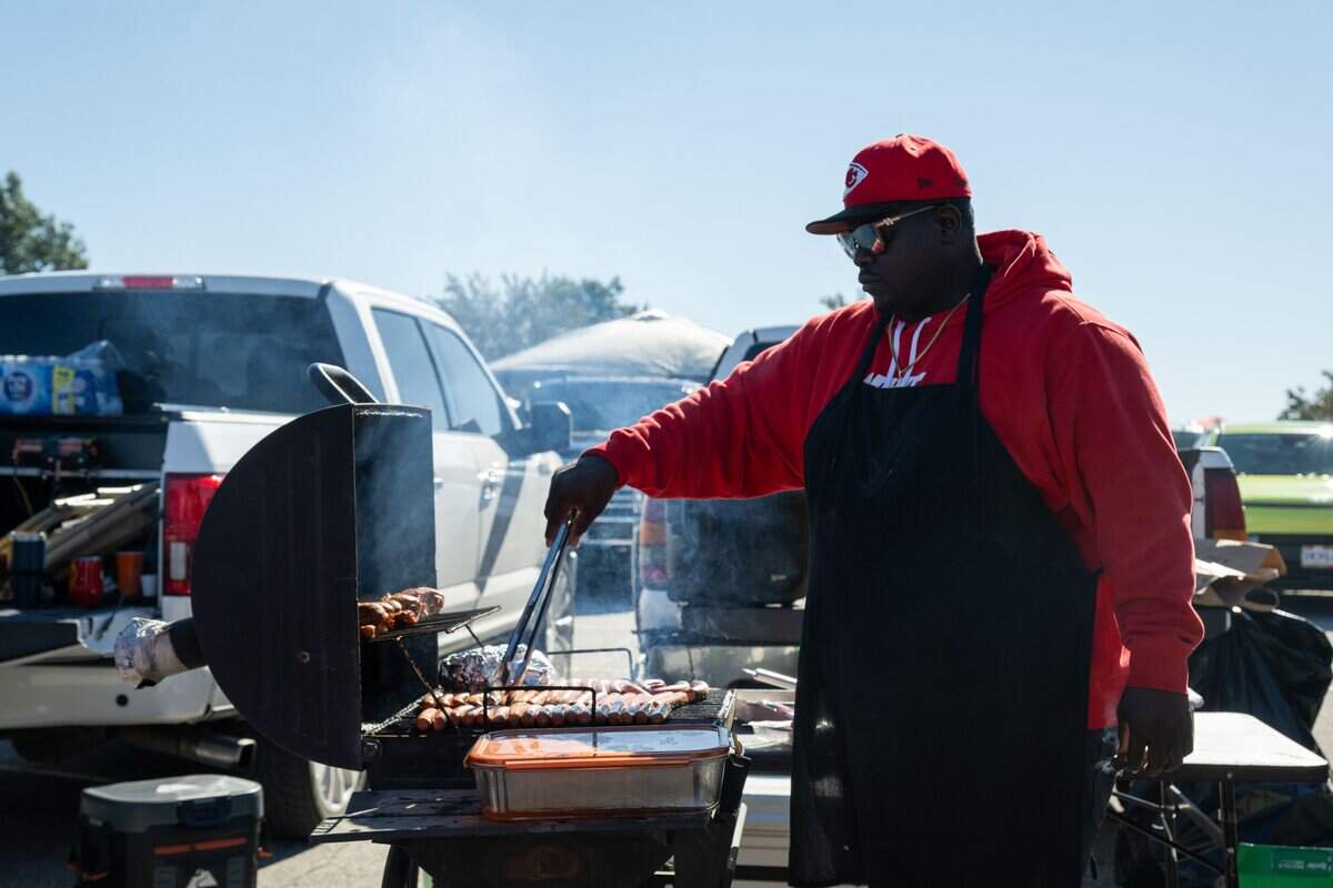 A fan grills meat in the parking lot outside the stadium prior to the Chiefs game vs. the Los Angeles Chargers, on Sunday, October 18, 2026, at Arrowhead Stadium.