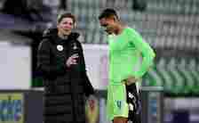 Wolfsburg's German head coach Oliver Glasner (L) chats with Wolfsburg's French defender Maxence Lacroix after the German first division Bundesliga ...