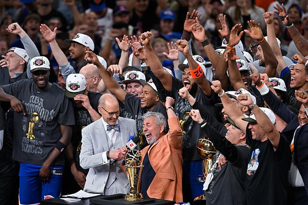 FILE - New York Knicks owner James L. Dolan celebrates with his players during an interview with Ernie Johnson Jr., after defeating the San Antonio Spurs in Game 5 of the NBA Finals basketball series, June 13, 2026, in San Antonio (AP Photo/Darren Abate, File)