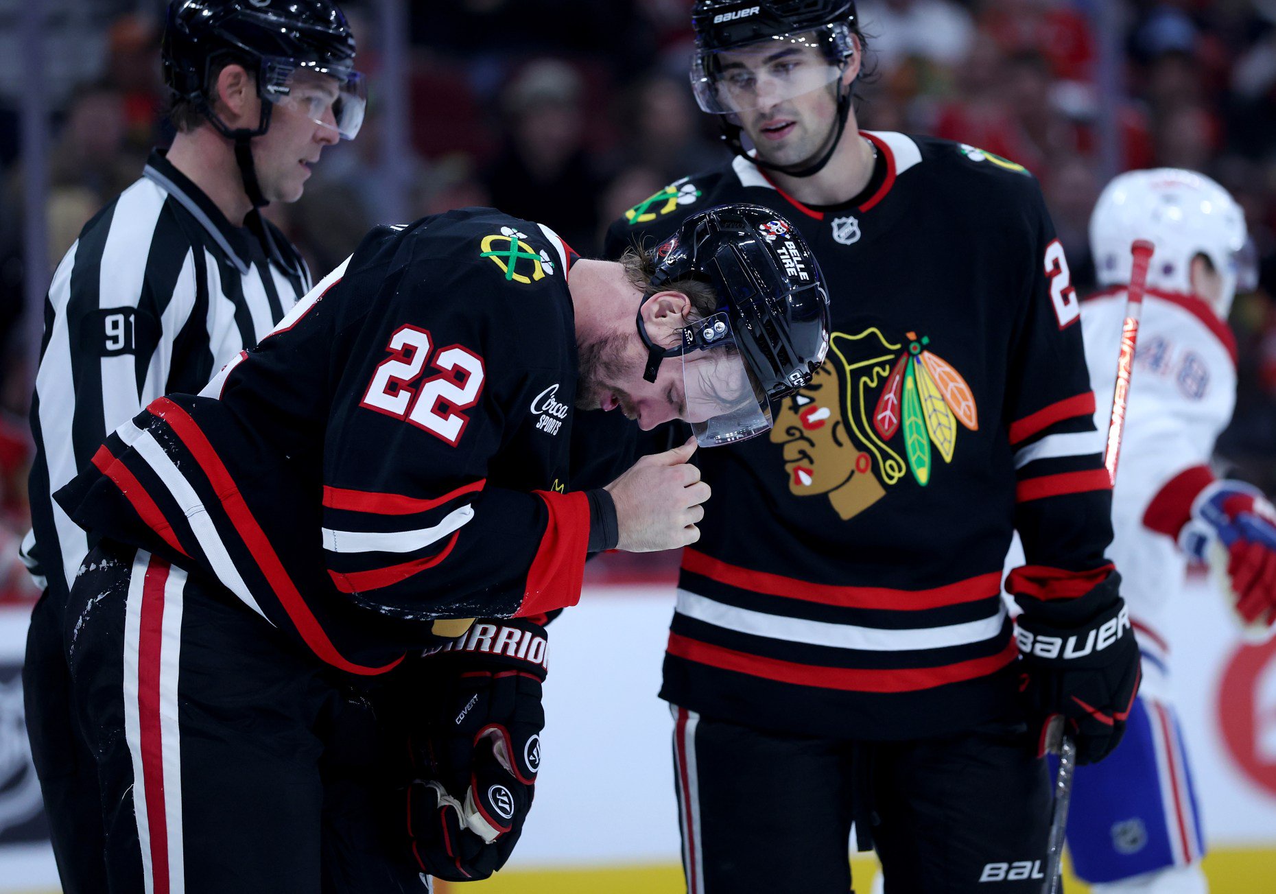 Chicago Blackhawks right wing Cole Smith (22) reacts after being hit in the face with a puck in the third period of a game against the Montréal Canadiens at the United Center in Chicago on Oct. 23, 2026. (Chris Sweda/Chicago Tribune)