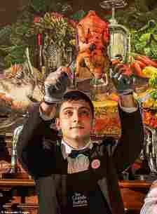 One of the waiters holds up a canard au sang ¿ or pressed duck